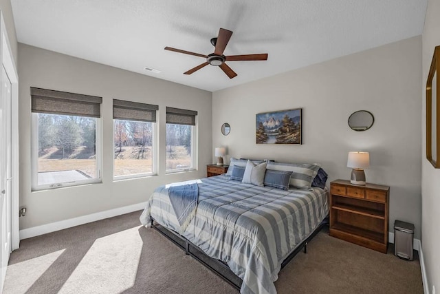 bedroom with a ceiling fan, visible vents, baseboards, and carpet flooring