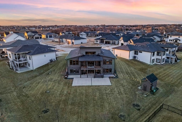 aerial view at dusk featuring a residential view