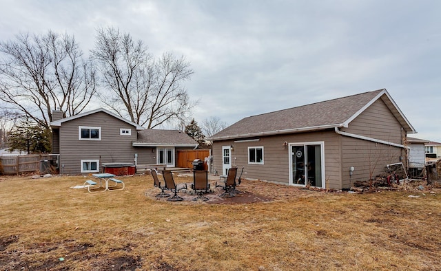 rear view of house featuring an outdoor fire pit, fence, a patio, and a yard