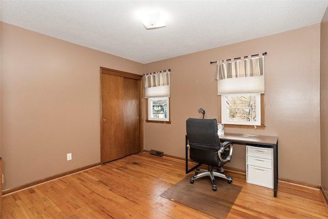 office with baseboards and light wood-style floors