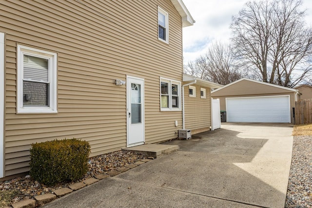 exterior space featuring a garage and an outbuilding