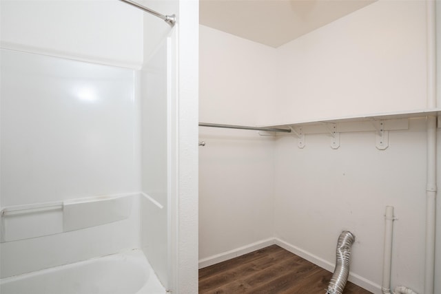 interior space with dark wood-style floors, laundry area, hookup for a washing machine, and baseboards