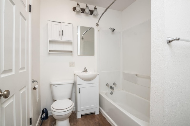 bathroom with  shower combination, toilet, wood finished floors, and vanity