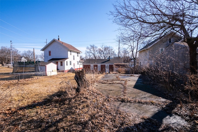 view of yard with a trampoline and fence