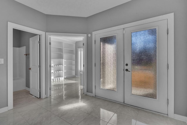 entrance foyer featuring french doors and baseboards