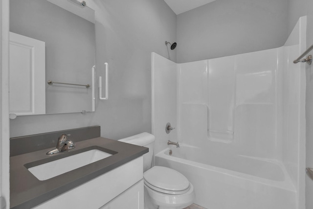 bathroom with shower / bathing tub combination, vanity, and toilet