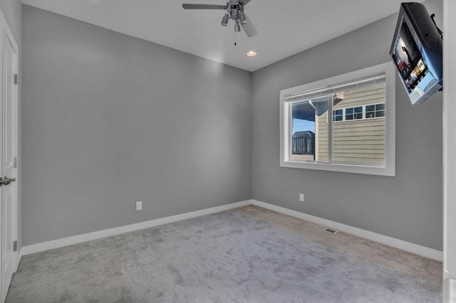 unfurnished room with recessed lighting, carpet flooring, a ceiling fan, visible vents, and baseboards