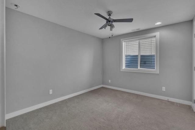 carpeted empty room featuring baseboards, visible vents, ceiling fan, and recessed lighting