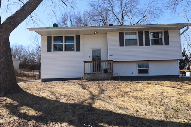 bi-level home featuring fence