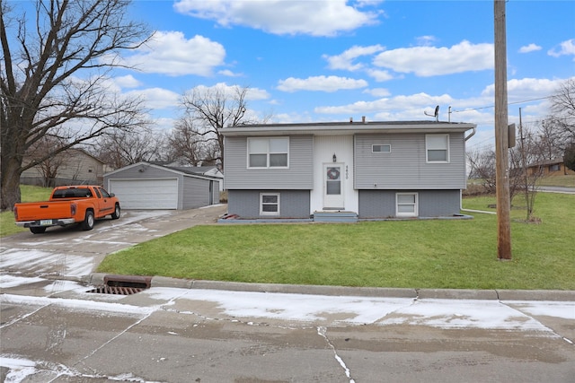 raised ranch with a detached garage, a front lawn, and an outdoor structure