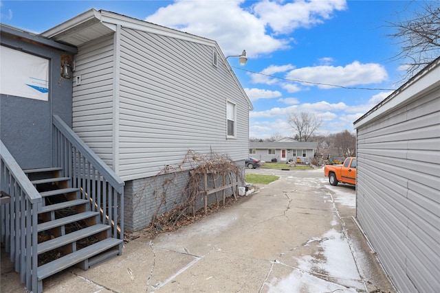 view of side of home with stairs