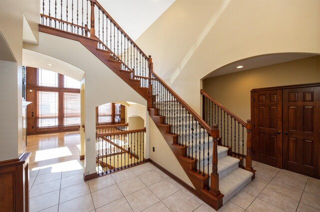 1205 NE 31st St, Ankeny, IA 50021 - stairway with a high ceiling, arched walkways, and tile patterned floors