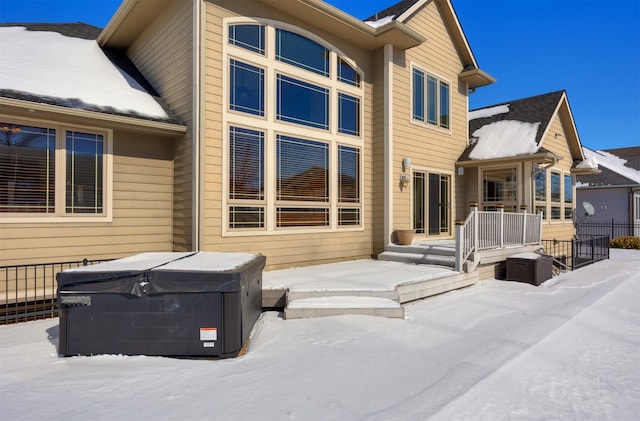 snow covered house with a hot tub