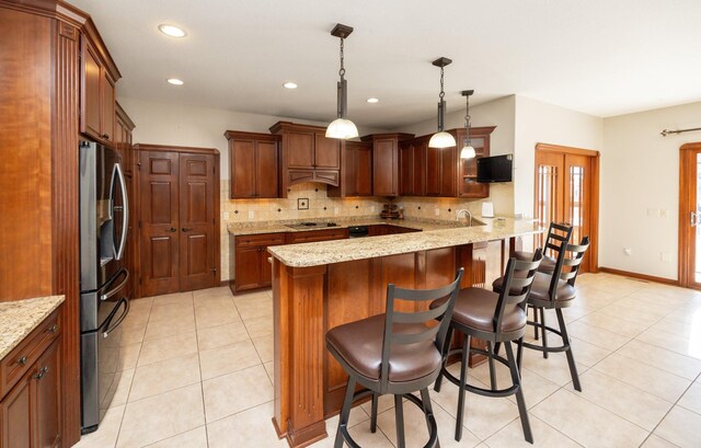 1205 NE 31st St, Ankeny, IA 50021 - kitchen featuring stainless steel refrigerator with ice dispenser, backsplash, light tile patterned floors, a breakfast bar area, and recessed lighting