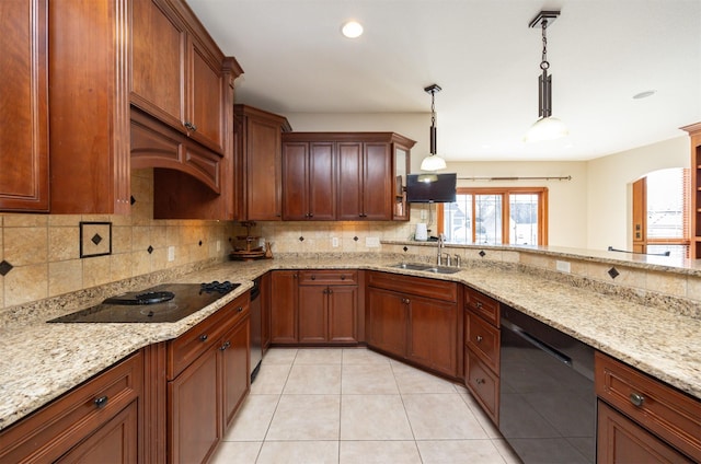 kitchen with light tile patterned floors, decorative backsplash, decorative light fixtures, black appliances, and a sink