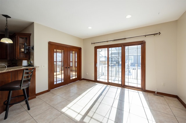 entryway featuring light tile patterned floors, recessed lighting, visible vents, baseboards, and french doors