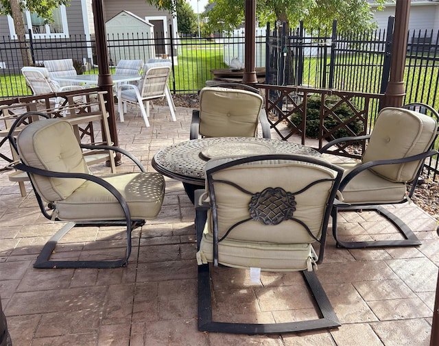 view of patio with outdoor dining space and fence