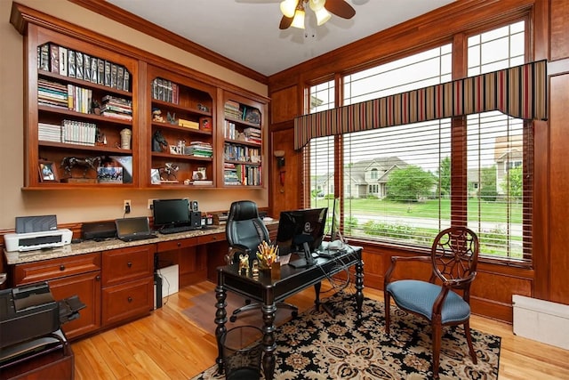 office area with crown molding, built in study area, ceiling fan, and light wood finished floors