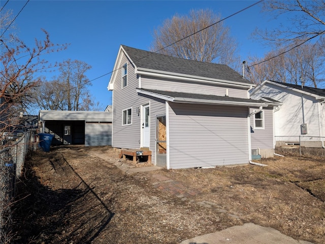 view of property exterior with fence and roof with shingles