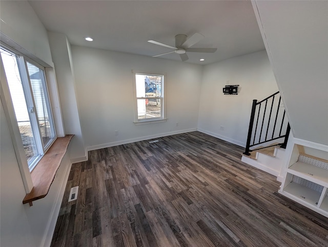 empty room with baseboards, visible vents, dark wood-style flooring, stairs, and recessed lighting