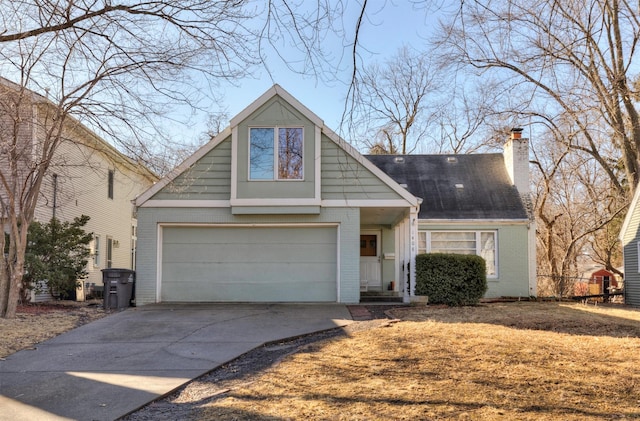 view of front of house featuring driveway, brick siding, a chimney, and an attached garage