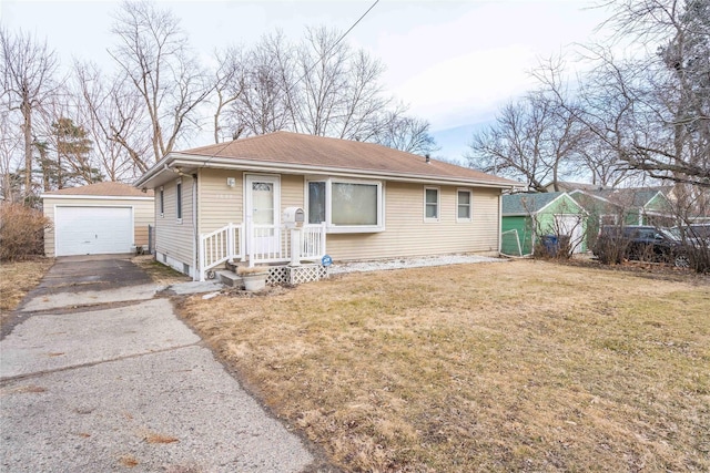 3839 34th St, Des Moines, IA 50310 - bungalow-style home with a garage, an outdoor structure, driveway, and a front lawn