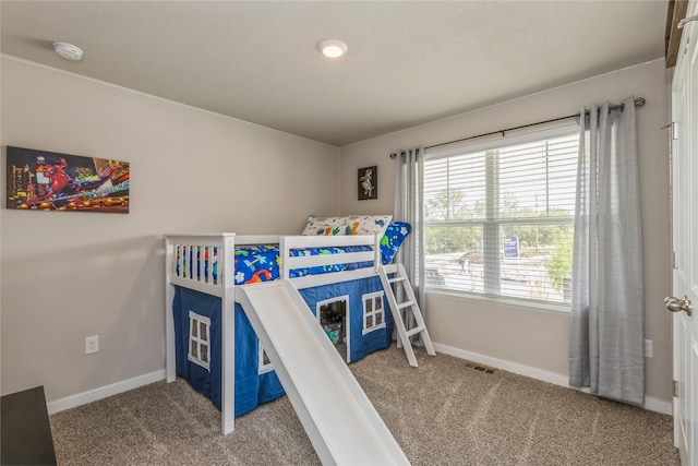 bedroom with carpet, visible vents, and baseboards