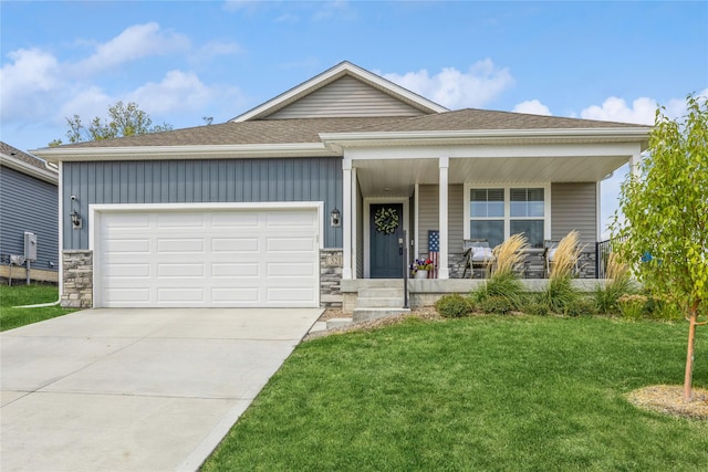 ranch-style home featuring concrete driveway, an attached garage, covered porch, a front lawn, and board and batten siding