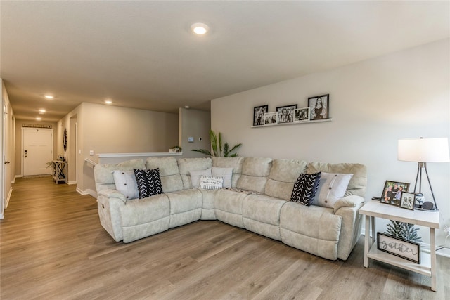 living area with light wood finished floors, baseboards, and recessed lighting