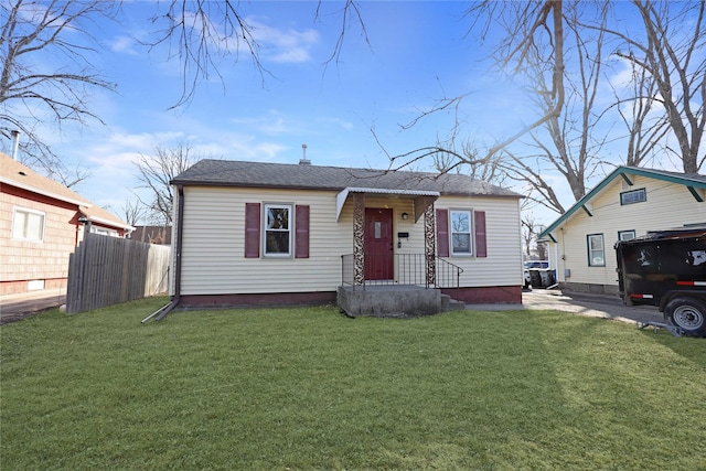 bungalow with a front yard and fence