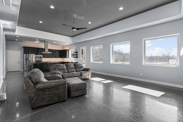 living area featuring ceiling fan, recessed lighting, visible vents, baseboards, and finished concrete flooring