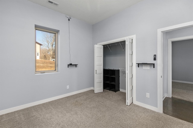 unfurnished bedroom with carpet floors, visible vents, and baseboards