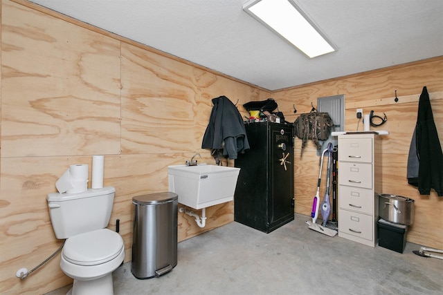 bathroom featuring toilet and concrete floors