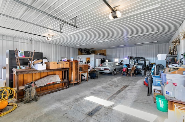 garage featuring metal wall and a garage door opener