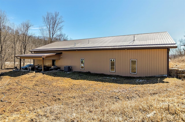 back of house with central air condition unit