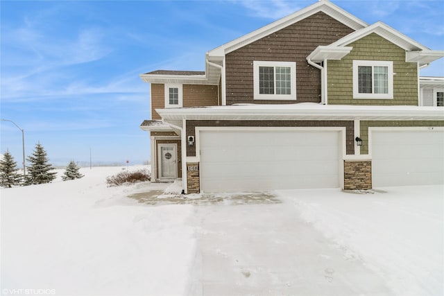 view of front of property featuring stone siding and an attached garage