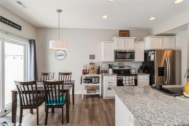 kitchen with dark wood-style flooring, stainless steel appliances, recessed lighting, visible vents, and white cabinetry