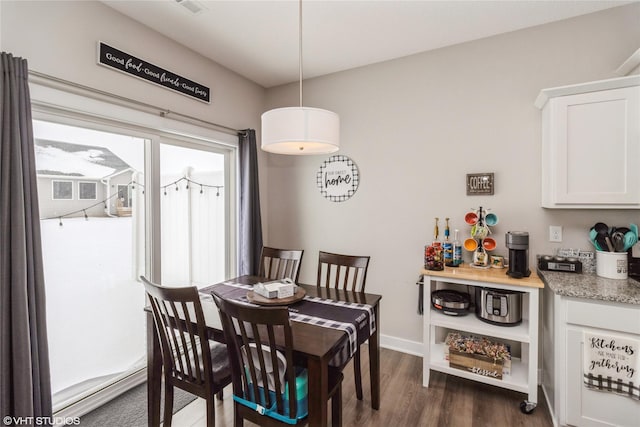 dining area with plenty of natural light, baseboards, and dark wood-style flooring