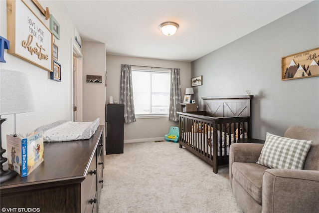 bedroom featuring a nursery area, carpet floors, and baseboards