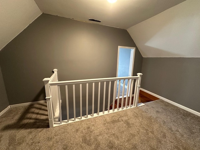 bonus room with carpet flooring, vaulted ceiling, visible vents, and baseboards