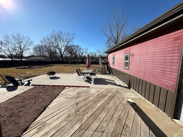 wooden deck with stairway, a patio, and a fire pit