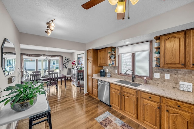 kitchen with dishwasher, open shelves, brown cabinetry, and a sink