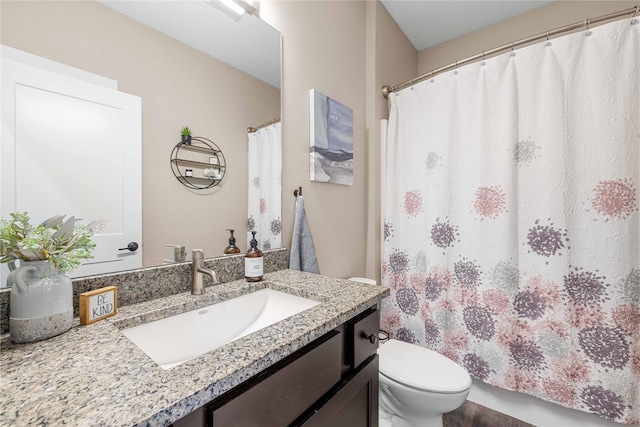 bathroom with vanity, toilet, and a shower with curtain