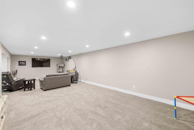 carpeted living area with baseboards and recessed lighting