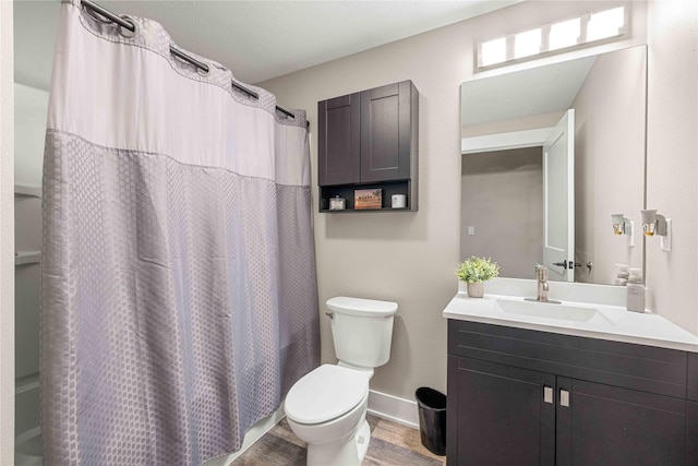 full bath with baseboards, toilet, wood finished floors, shower / bath combination with curtain, and vanity