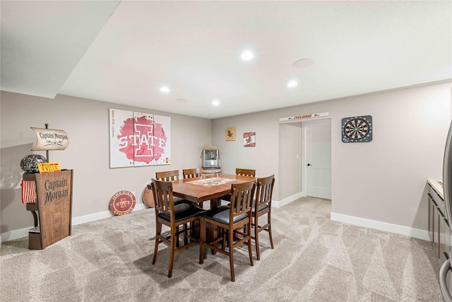 dining room featuring baseboards, recessed lighting, and light colored carpet