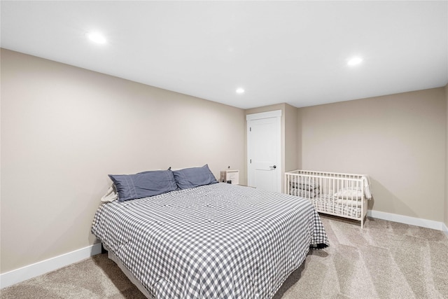 carpeted bedroom featuring baseboards and recessed lighting