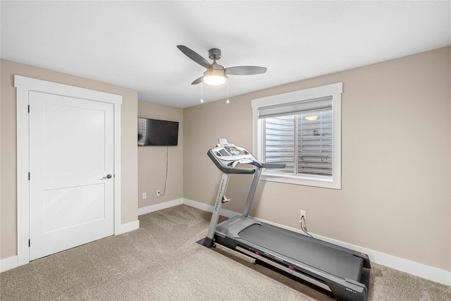 workout room with carpet, a ceiling fan, and baseboards