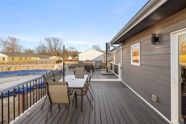 wooden deck with outdoor dining area, a residential view, fence, and a fenced in pool