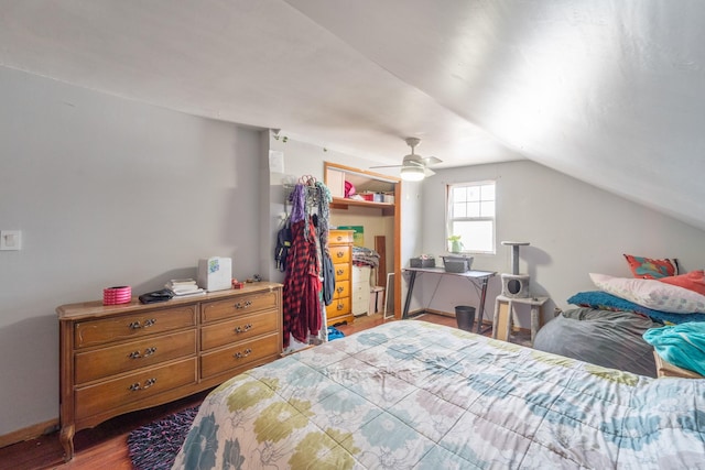 bedroom featuring lofted ceiling, a closet, baseboards, and wood finished floors